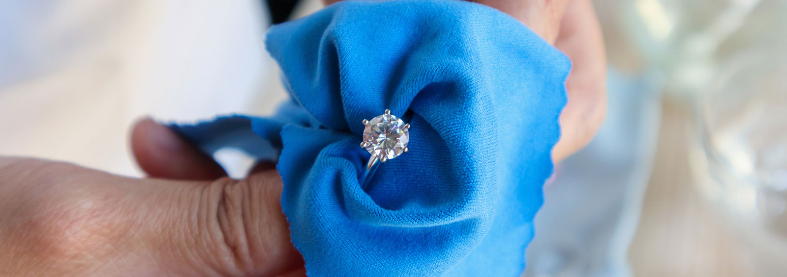 Jeweller Hand Polishing And Cleaning Jewelry Diamond Ring With M